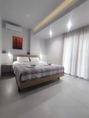 a bedroom with a bed and a large window at MC Luxury Living in Chania Town