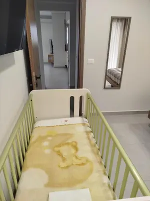 a crib with a blanket on it in a room at MC Luxury Living in Chania Town
