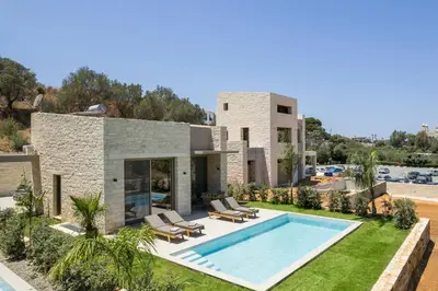 a villa with a swimming pool and a house at La Divina Luxury Villas with Heated Pool in Daratso