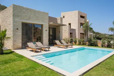 a swimming pool in the backyard of a house at La Divina Luxury Villas with Heated Pool in Daratso