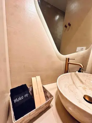 a bathroom with a sink and a book on the counter at Devina Residence 2025 , Luxury City Jacuzzi Apartment in Chania Town