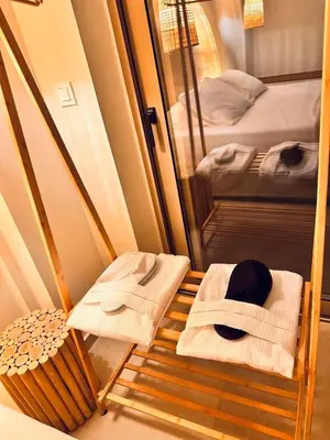 a room with two beds with towels and a mirror at Devina Residence 2025 , Luxury City Jacuzzi Apartment in Chania Town