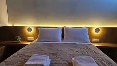 a bedroom with a large bed with two white pillows at Reflections Apartments in Stalos