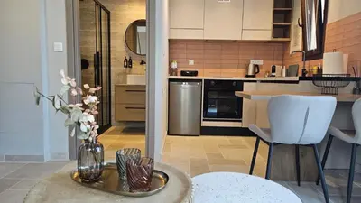 a kitchen with a vase of flowers on a table at Reflections Apartments in Stalos