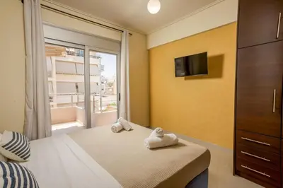 a bedroom with a bed with towels on it at Zen City Beach Apartment in Chania Town
