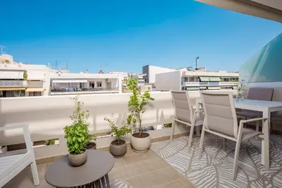 a balcony with a table and chairs and plants at Kira Elegant City Nest in Chania Town