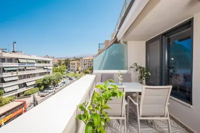 a balcony with a table and chairs and a view of a city at Kira Elegant City Nest in Chania Town