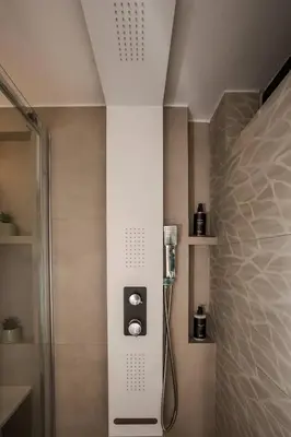 a shower stall in a bathroom with a shower at Demmi Central 2BR Designer Apt in Chania Town