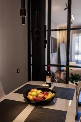 a bowl of fruit on a table in a kitchen at Demmi Central 2BR Designer Apt in Chania Town