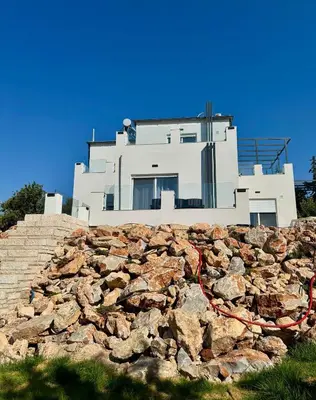 a house on top of a stone wall at Villa & Apartament Armonia 4 Gaia Vita Gavalochori-Vamos KRETA in Vamos