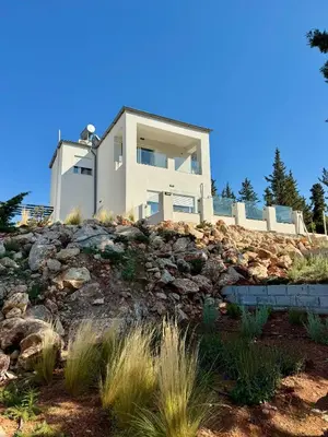 a house on top of a rocky hill at Villa & Apartament Armonia 4 Gaia Vita Gavalochori-Vamos KRETA in Vamos