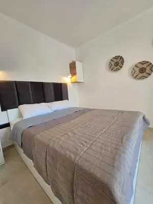a bedroom with a large bed with a brown blanket at Villa & Apartament Armonia 4 Gaia Vita Gavalochori-Vamos KRETA in Vamos