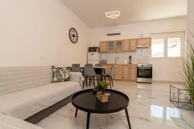 a living room with a couch and a table at Casa calma! in Kountoura Selino