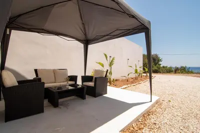 a tent with two chairs and a table under it at Casa calma! in Kountoura Selino