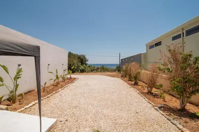 a dirt road next to a building with a tent at Casa calma! in Kountoura Selino