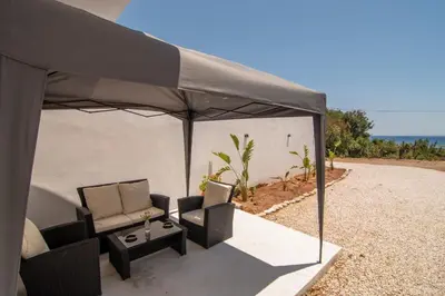 a black tent with two chairs and a table at Casa calma! in Kountoura Selino