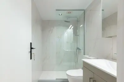 a bathroom with a shower and a toilet and a sink at Edward Luxury Suites in Chania Town