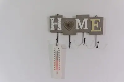 a cricket bat and a thermometer hanging on a wall at Depi's Home in Kissamos
