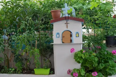 a small bird house in a garden with flowers at Depi's Home in Kissamos
