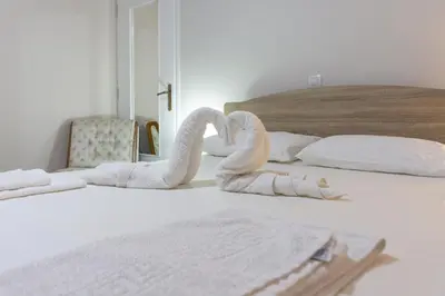 two swans made to look like towels on a bed at Depi's Home in Kissamos