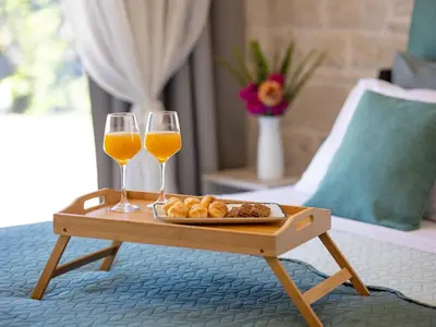 a tray of food and two glasses of wine on a table at PanStel - Villa Solene with private pool in Ayiá