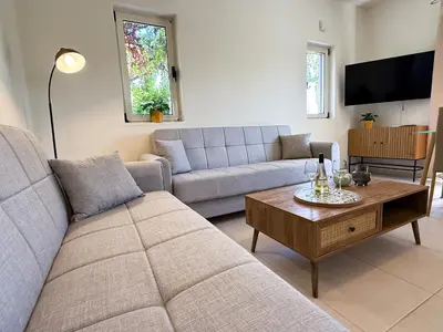 a living room with a couch and a table at Villa Karneios in Tavronitis
