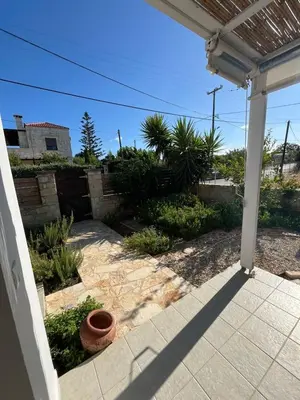 an outside view of a yard with a patio at Villa Karneios in Tavronitis