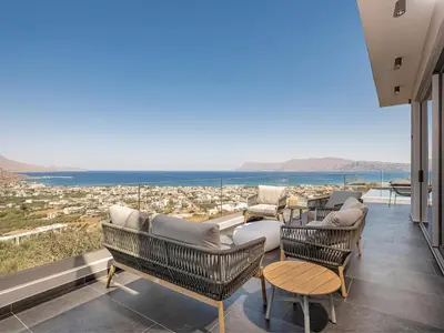 a balcony with furniture and a view of the ocean at Villa Thealon I New luxury villa with sea view and private infinity pool in Kissamos