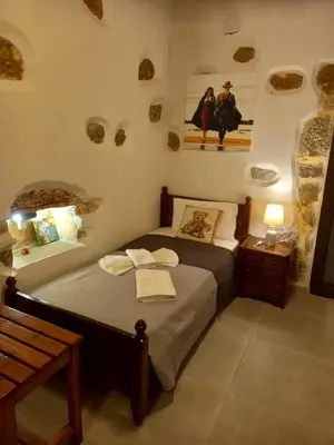 a bedroom with a bed with towels on it at Villa Makyva in Kámboi