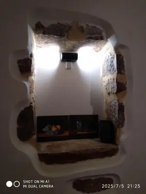 a living room with a fireplace in a wall at Villa Makyva in Kámboi