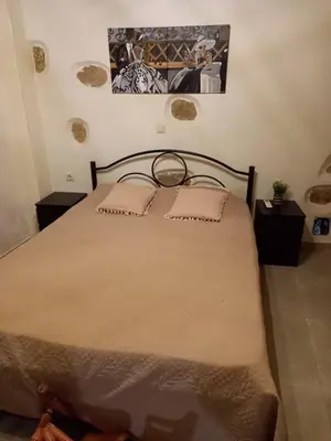 a bedroom with a large bed with two night stands at Villa Makyva in Kámboi