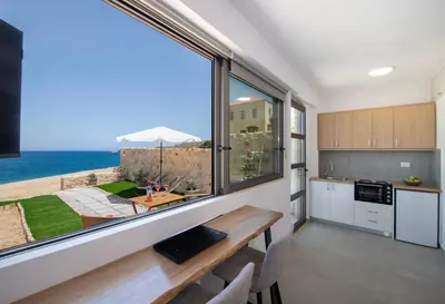 a kitchen with a table and a view of the ocean at The Seaside Nest in Chania Town