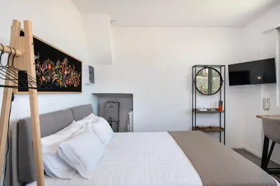 a bedroom with a bed and a desk in a room at The Seaside Nest in Chania Town