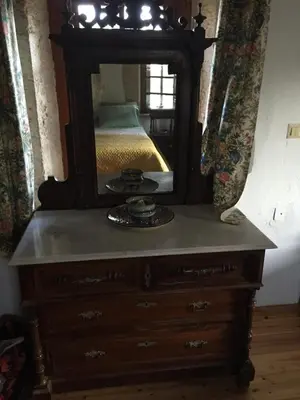 a dresser with a mirror on top of it at Casa Aptera in Megála Khoráfia