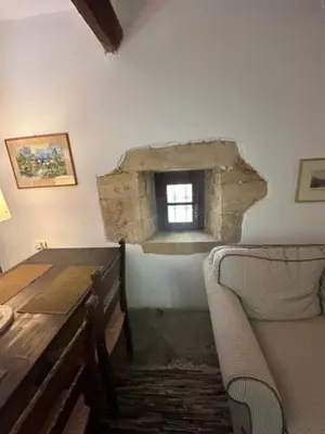 a room with a couch and a table and a window at Casa Aptera in Megála Khoráfia