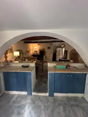 a large kitchen with an archway in a room at Casa Aptera in Megála Khoráfia