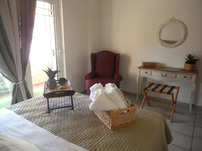 a bedroom with a bed with a chair and a table at Casa D' Amelia in Chania Town