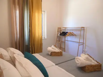a room with a bed with towels and a mirror at Casa D' Amelia in Chania Town