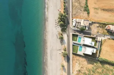 an aerial view of a beach and the water at Gemini Villas Chania - Calma & Siesta in Maleme