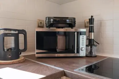 a microwave sitting on top of a kitchen counter at Stella's Traditional House Near the City in SFakianalíon