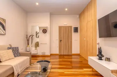 a living room with a couch and a glass table at SUITEArT 1 Stylish apartment in Chania Town
