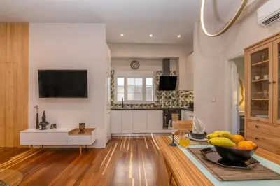 a kitchen with a bowl of fruit on a table at SUITEArT 1 Stylish apartment in Chania Town
