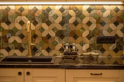 a kitchen with a sink and a tiled wall at SUITEArT 2 Exceptional apartment in Chania Town