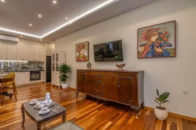 a large living room with a table and a tv at SUITEArT 2 Exceptional apartment in Chania Town