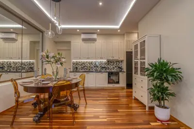 a kitchen with a table and chairs and a dining room at SUITEArT 2 Exceptional apartment in Chania Town