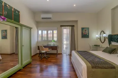 a bedroom with a bed and a desk in it at SUITEArT 2 Exceptional apartment in Chania Town