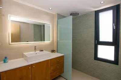 a bathroom with a sink and a mirror at Katakis Afroditi-Athina in Agios Onoufrios