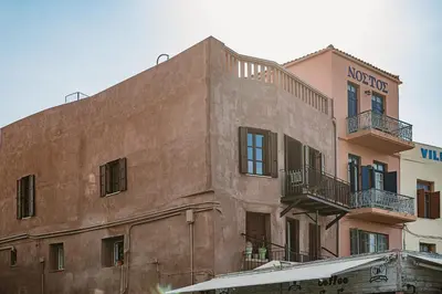 a brown building with balconies on the side of it at Evrima High End Residence in Chania Town