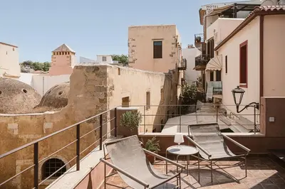 a balcony with two chairs and a table at Evrima High End Residence in Chania Town