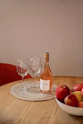 a bottle of wine and two wine glasses on a table at Light House Chania - 5 Min to Beach and Free Parking in Chania Town